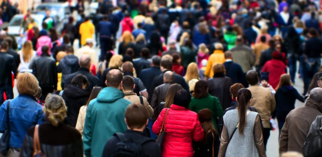 Crowd of people walking through a city, representing the nations and the opportunity to welcome strangers with the love of Christ.