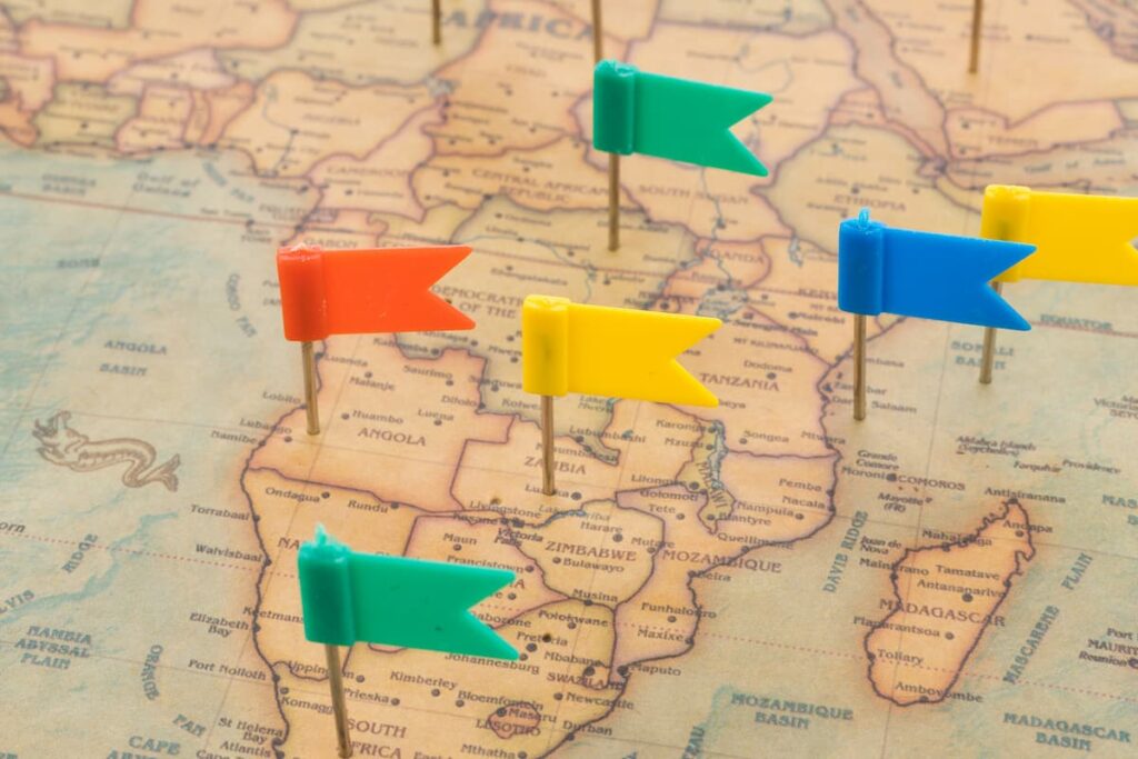 Close up colorful flags on map