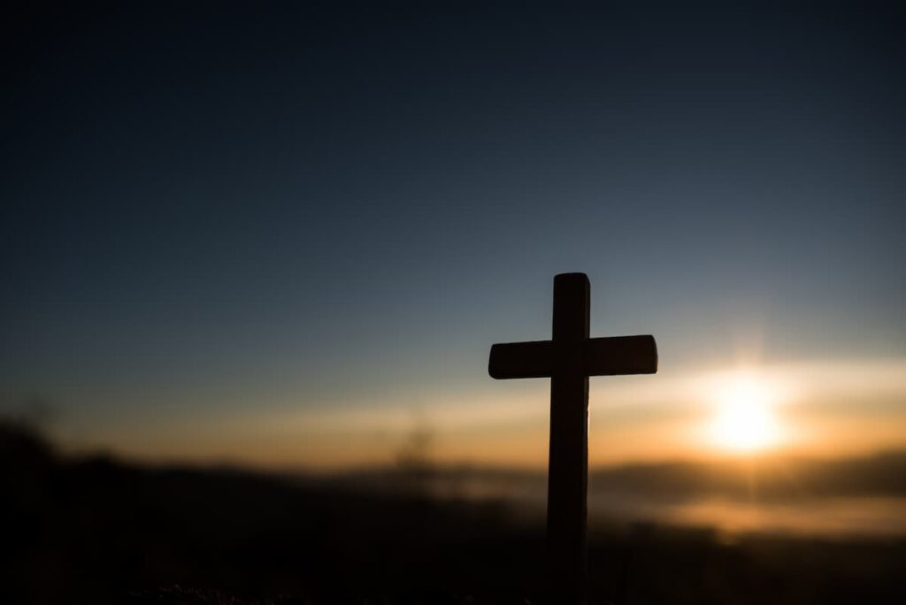 Silhouette of a cross at sunrise